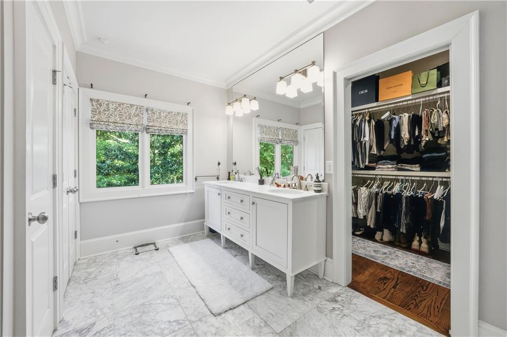 1295 Cumberland Road Northeast Atlanta, GA 30306 - Photo 57 of 71 a bathroom with a sink a mirror and a bathtub next to a window