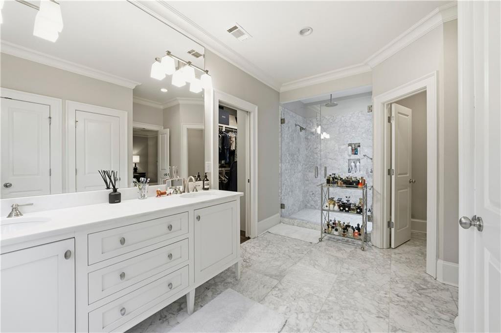1295 Cumberland Road Northeast Atlanta, GA 30306 - Photo 58 of 71 a spacious bathroom with a double vanity sink a mirror and shower