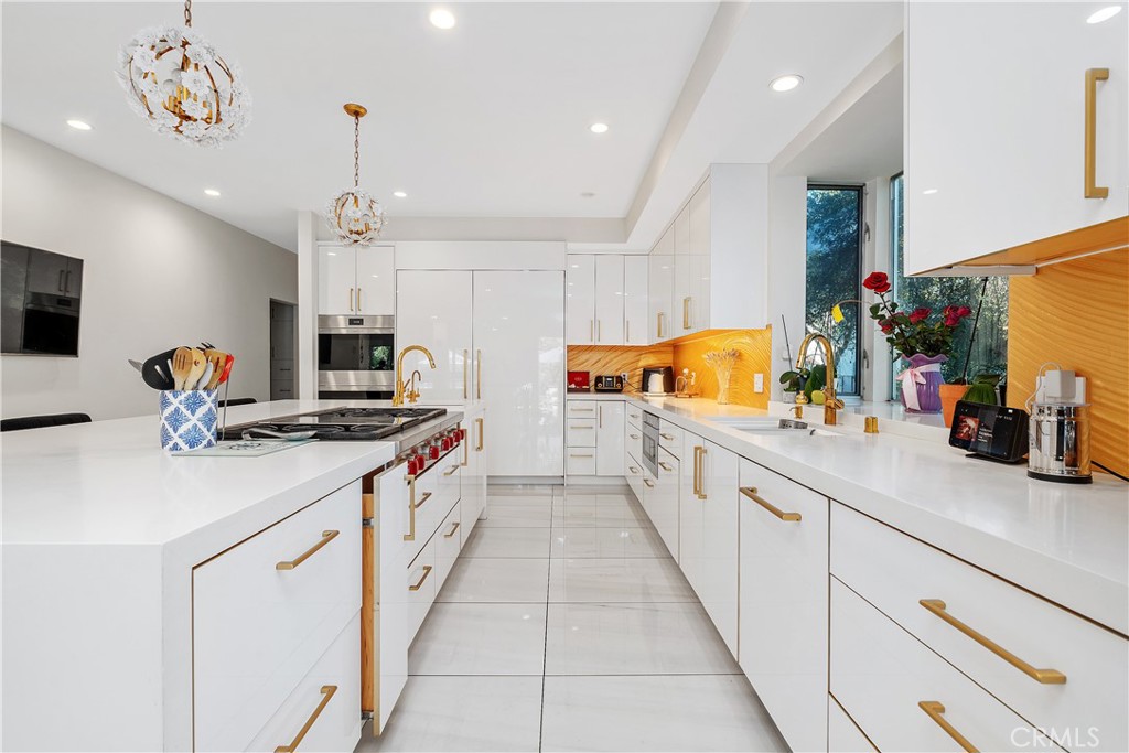 22 Round Up Road Bell Canyon, CA 91307 - Photo 12 of 39 a kitchen with stainless steel appliances a sink and a stove