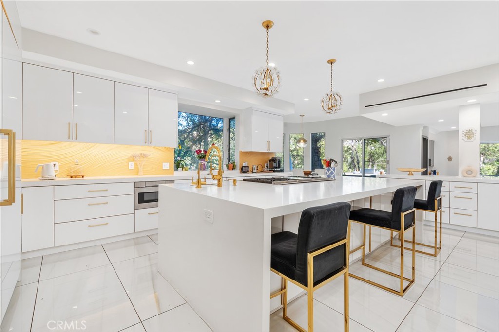 22 Round Up Road Bell Canyon, CA 91307 - Photo 15 of 39 a kitchen with stainless steel appliances kitchen island granite countertop a stove a sink and a refrigerator