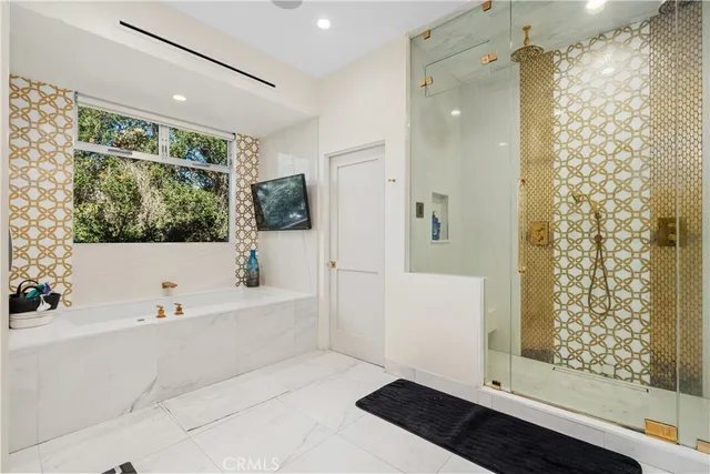 a bathroom with a bathtub and a shower