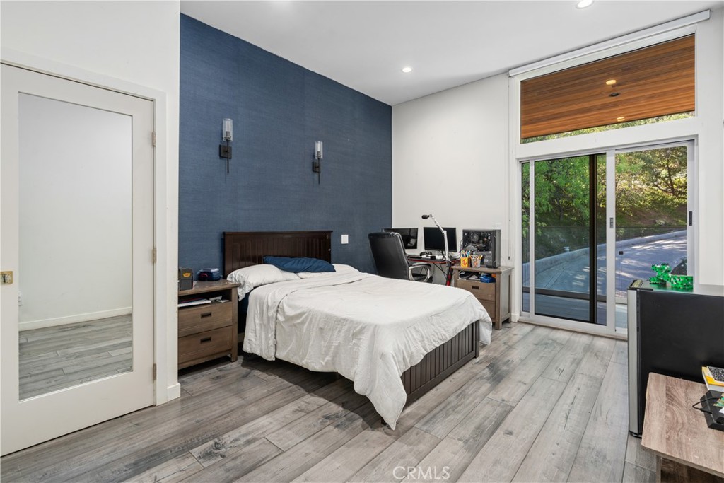 22 Round Up Road Bell Canyon, CA 91307 - Photo 24 of 39 a bedroom with a bed and wooden floor