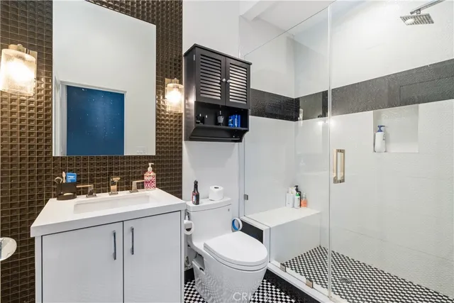 a bathroom with a sink toilet and shower