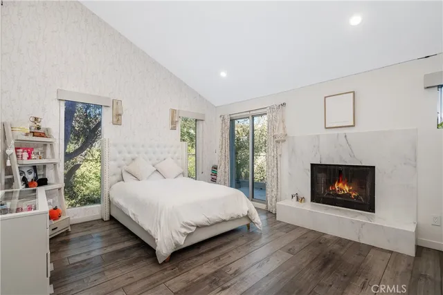 a bedroom with a bed and a fireplace