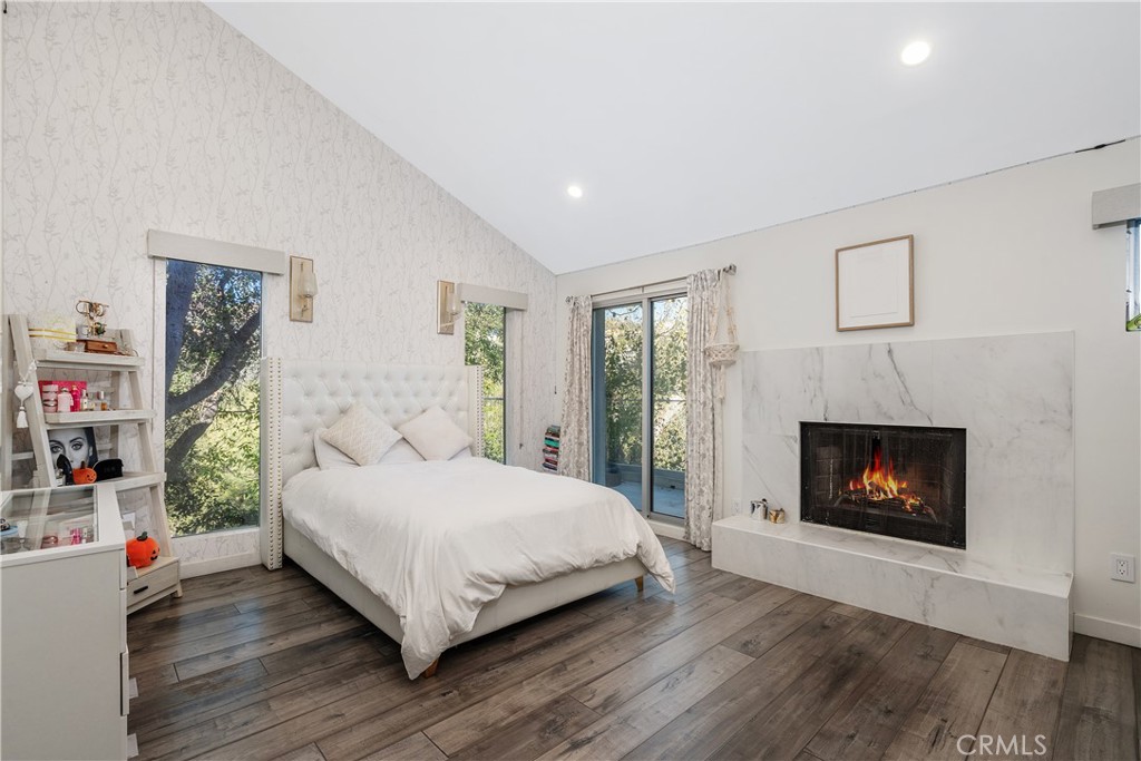 22 Round Up Road Bell Canyon, CA 91307 - Photo 27 of 39 a bedroom with a bed and a fireplace
