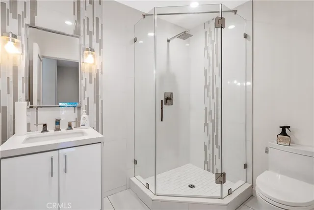 a bathroom with a shower a toilet and a sink