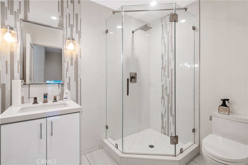 22 Round Up Road Bell Canyon, CA 91307 - Photo 32 of 39 a bathroom with a shower a toilet and a sink