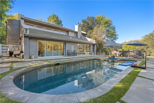 a view of a house with swimming pool and porch