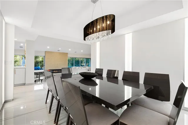 a view of a dining room with furniture and a potted plant