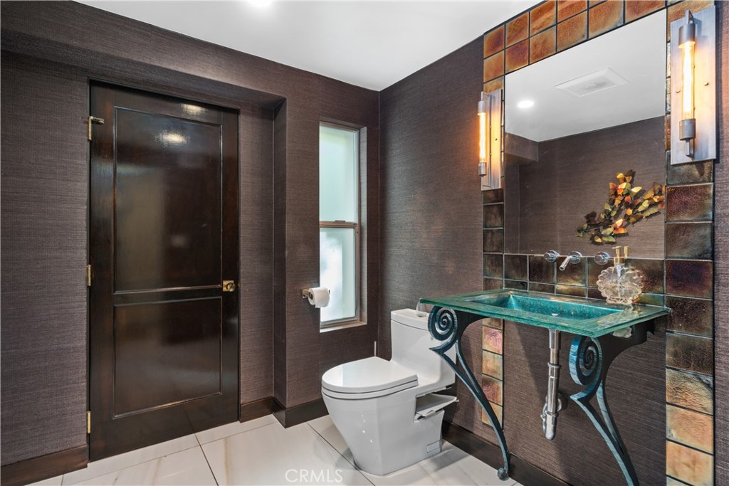 22 Round Up Road Bell Canyon, CA 91307 - Photo 5 of 39 a bathroom with a toilet a sink and mirror