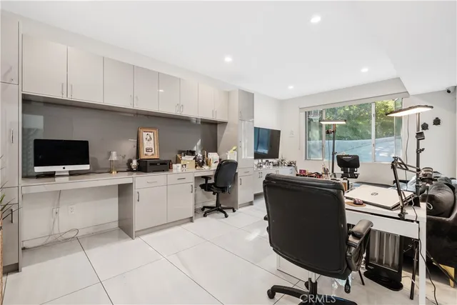 a view of a kitchen with kitchen island a sink a counter top space and appliances