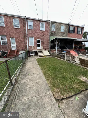 a view of a yard in front of a brick house