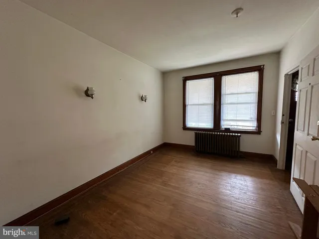 a view of an empty room and wooden floor