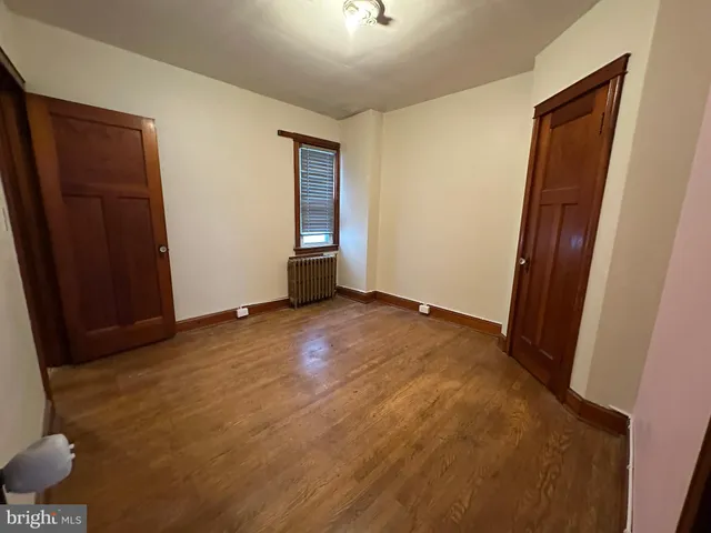 an empty room with wooden floor