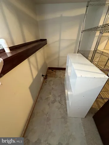 a kitchen with sink a stove and white cabinets