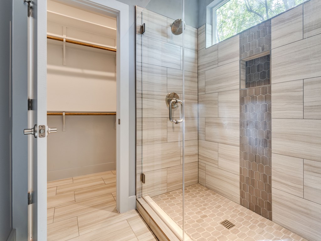 406 Post Rd Drive, Unit 1 Austin, TX 78704 - Photo 11 of 30 another view of the primary bathroom, showing the gorgeously tiled shower with walk in closet nearby