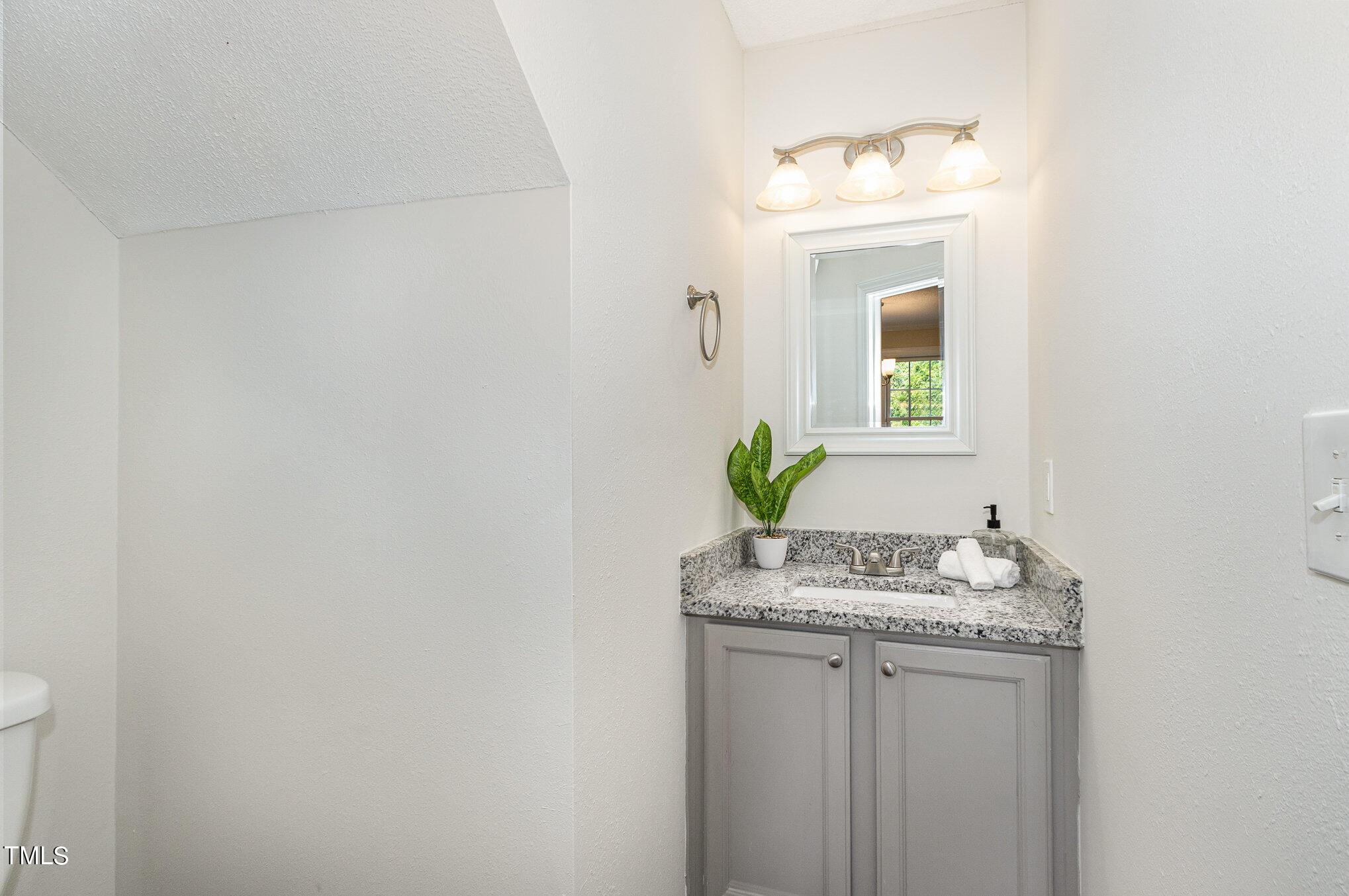 6004 Swales Way Raleigh, NC 27603 - Photo 11 of 24 a bathroom with a granite countertop sink and a mirror