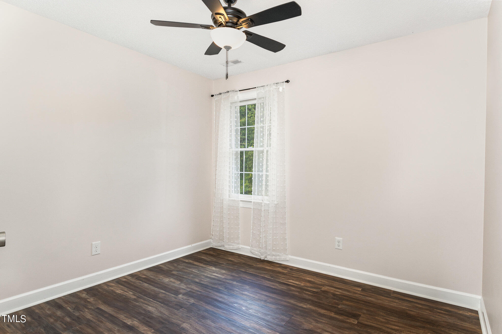 6004 Swales Way Raleigh, NC 27603 - Photo 16 of 24 an empty room with wooden floor ceiling fan and window