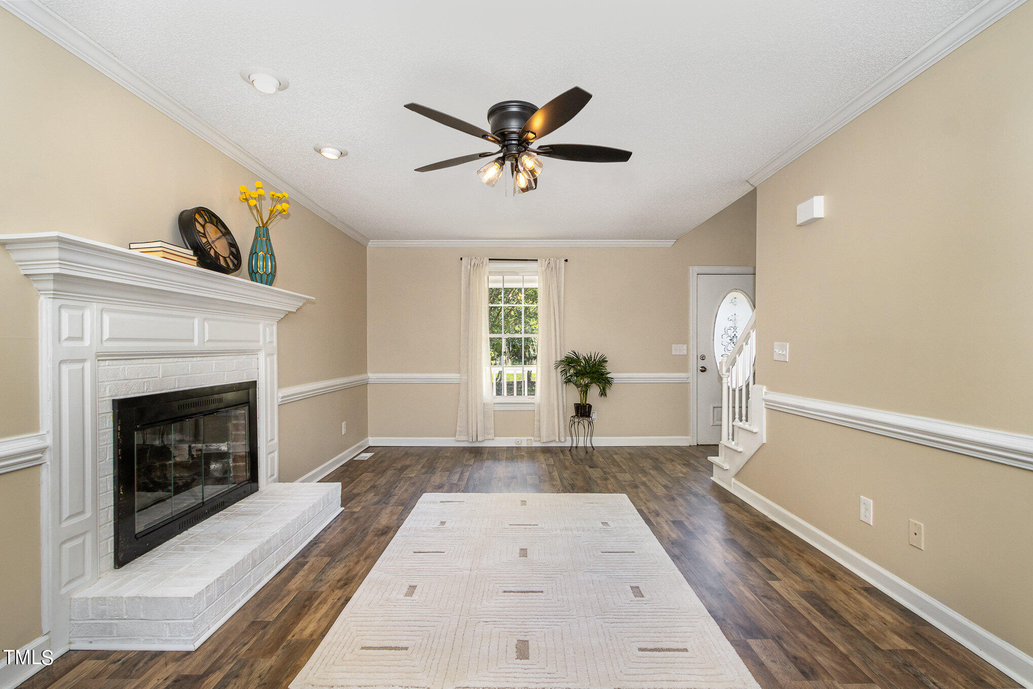 6004 Swales Way Raleigh, NC 27603 - Photo 4 of 24 a very nice looking living room with a fireplace and a ceiling fan