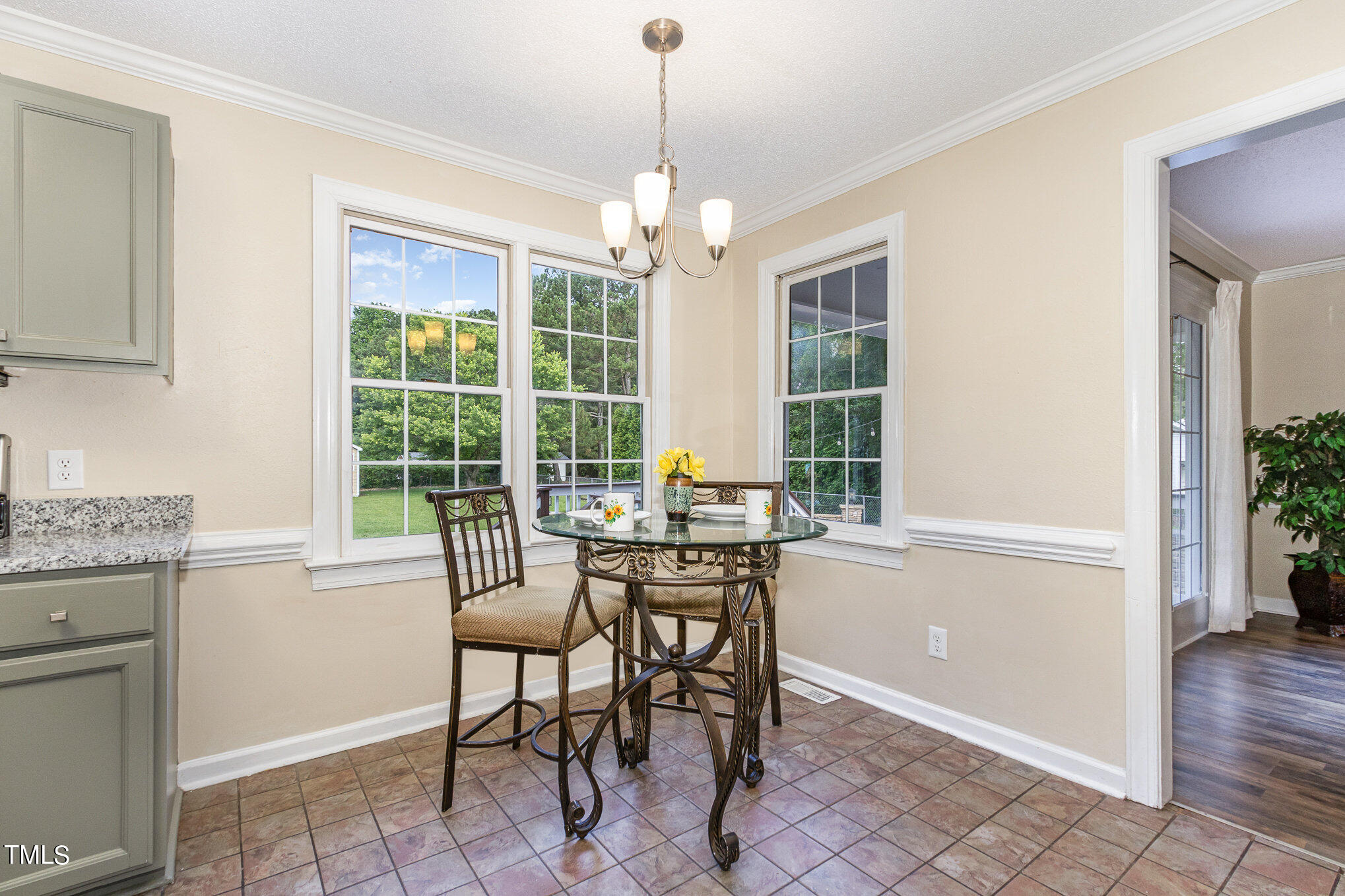 6004 Swales Way Raleigh, NC 27603 - Photo 8 of 24 a dining room with chandelier and wooden floor