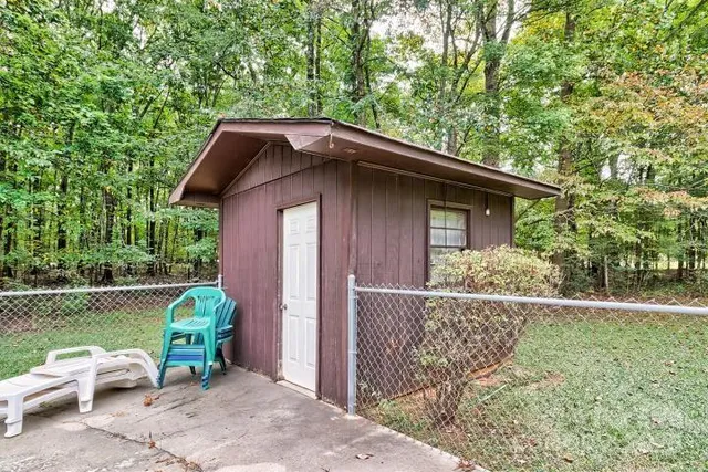 a view of backyard with outdoor seating and green space