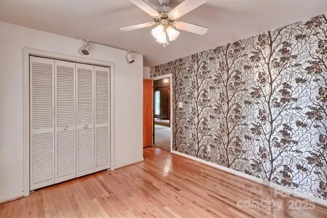 a living room with furniture and a ceiling fan