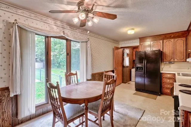 a kitchen with a refrigerator stove top oven and sink