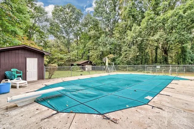 a view of a backyard with swimming pool