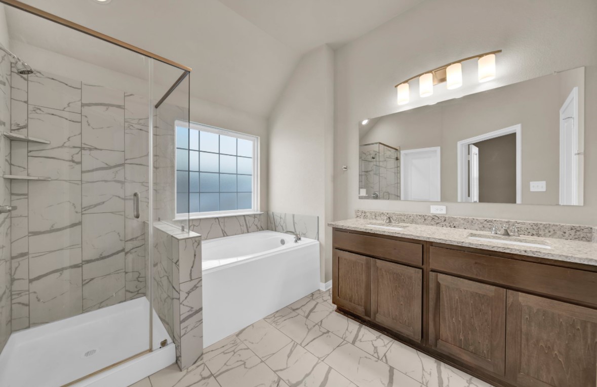 4791 Native Tree Lane Bryan, TX 77845 - Photo 13 of 22 a bathroom with a tub sink and mirror