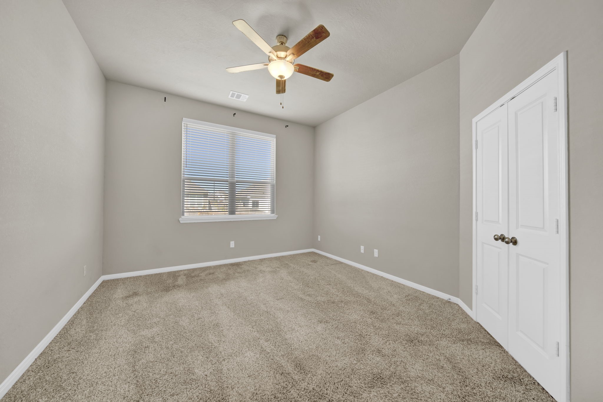 4791 Native Tree Lane Bryan, TX 77845 - Photo 10 of 22 an empty room with windows and a ceiling fan