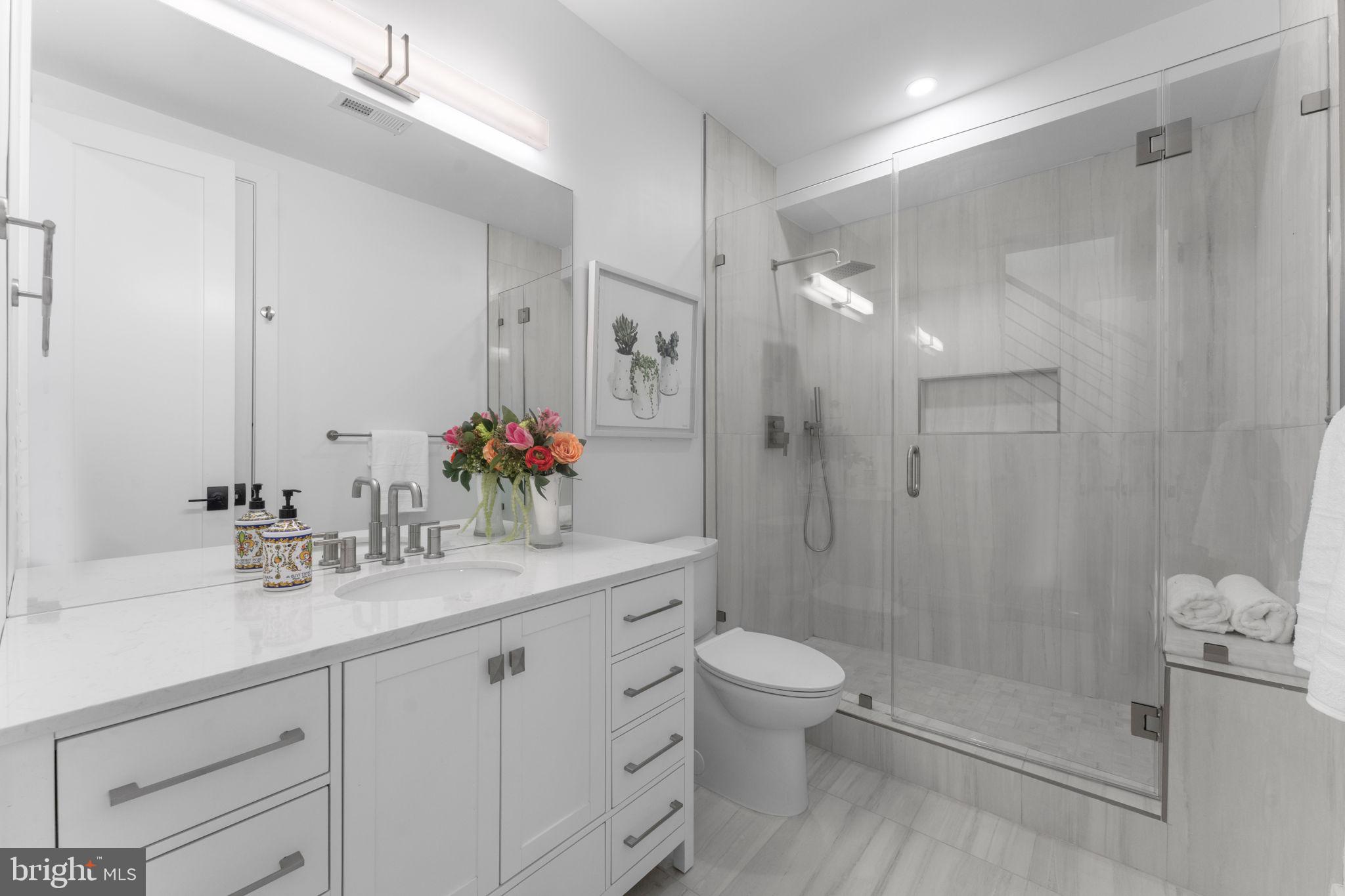 602 U Street Northwest Washington, DC 20001 - Photo 18 of 39 a bathroom with a shower sink vanity mirror and toilet
