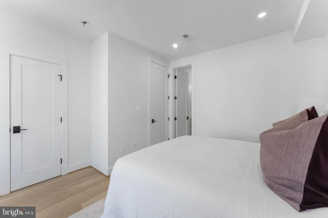 a bedroom with a bed and a chair