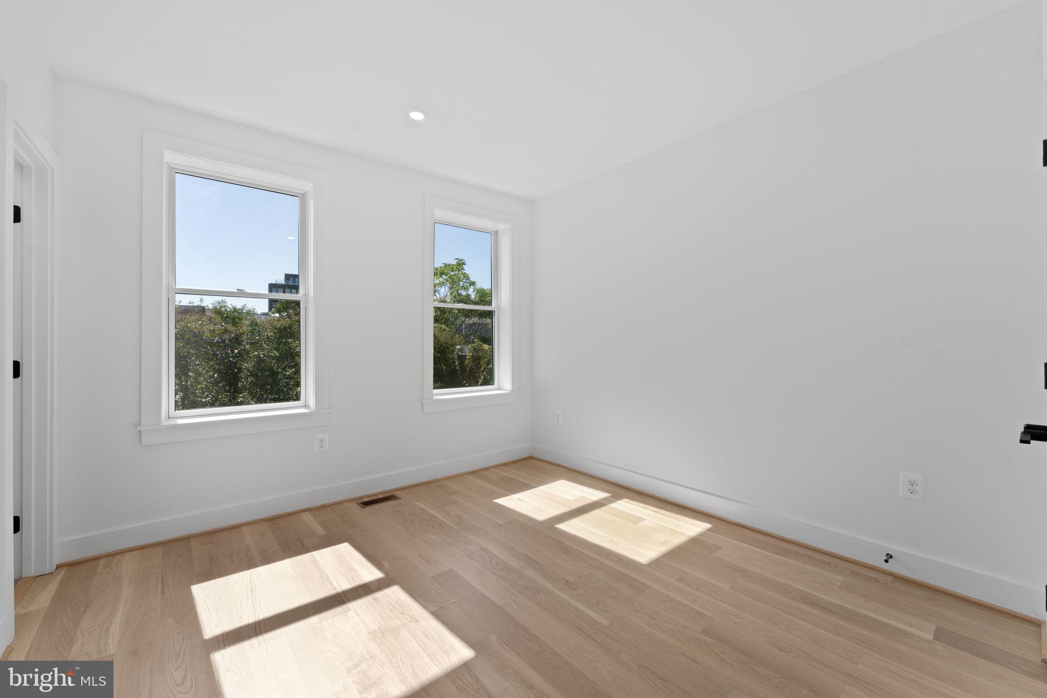 602 U Street Northwest Washington, DC 20001 - Photo 26 of 39 an empty room with wooden floor and windows