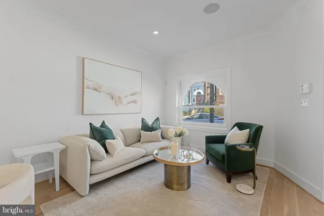 a living room with furniture a window and a table