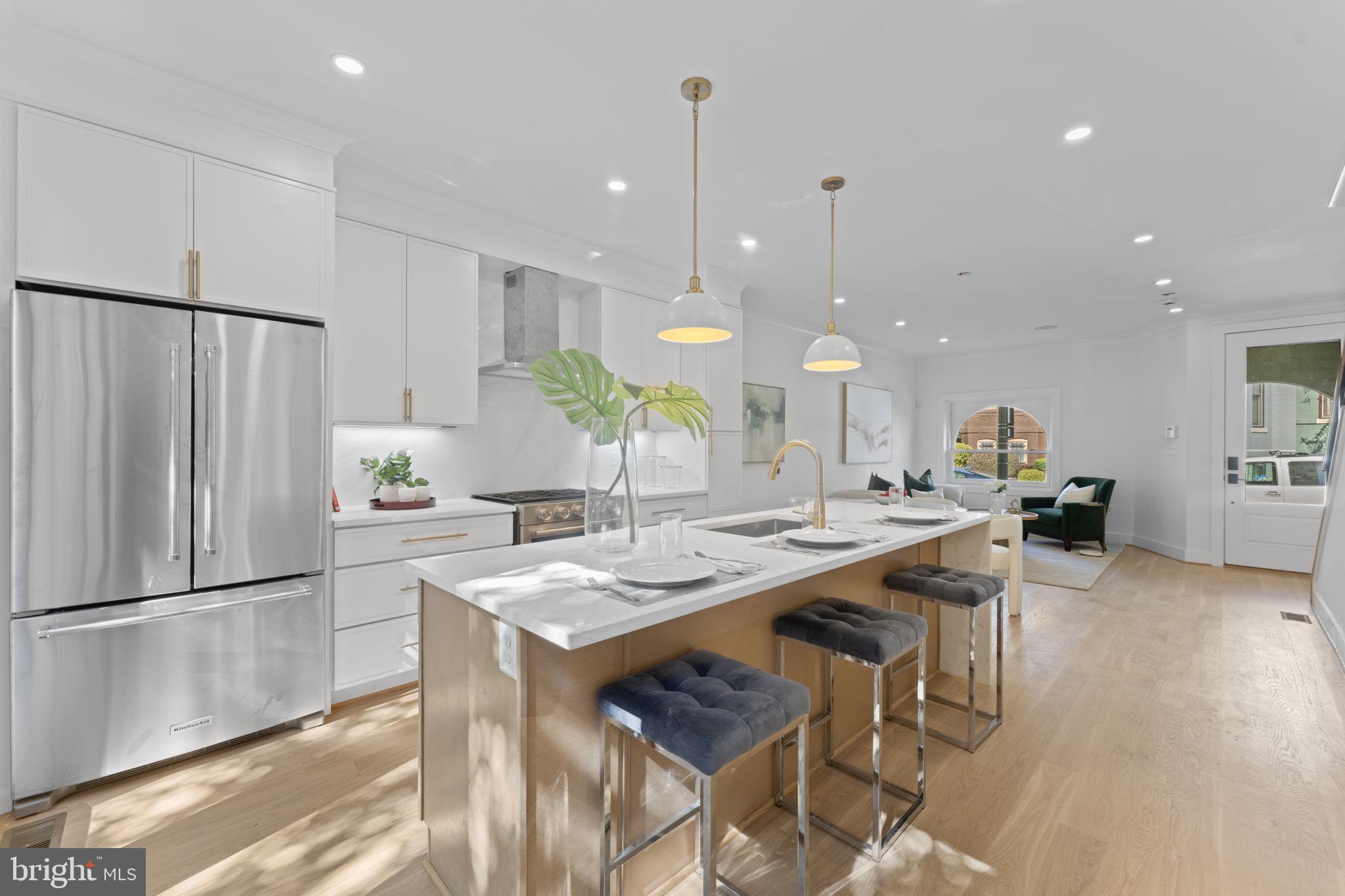 602 U Street Northwest Washington, DC 20001 - Photo 7 of 39 a kitchen with stainless steel appliances granite countertop table chairs refrigerator and microwave