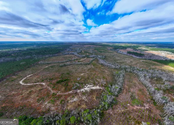 a view of a field with wooden fence