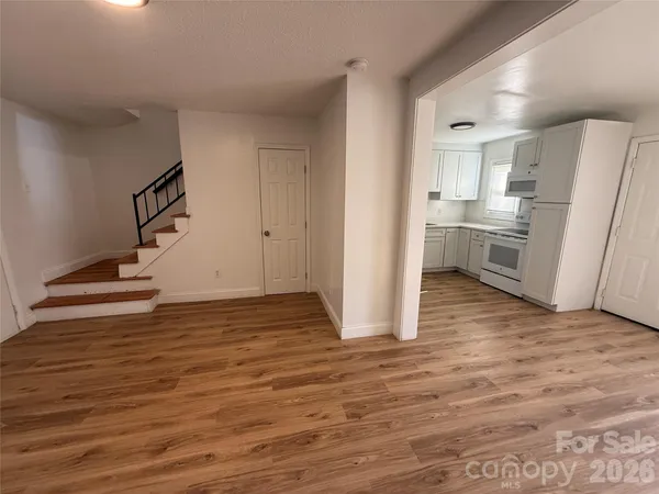 a kitchen with a sink a refrigerator and cabinets