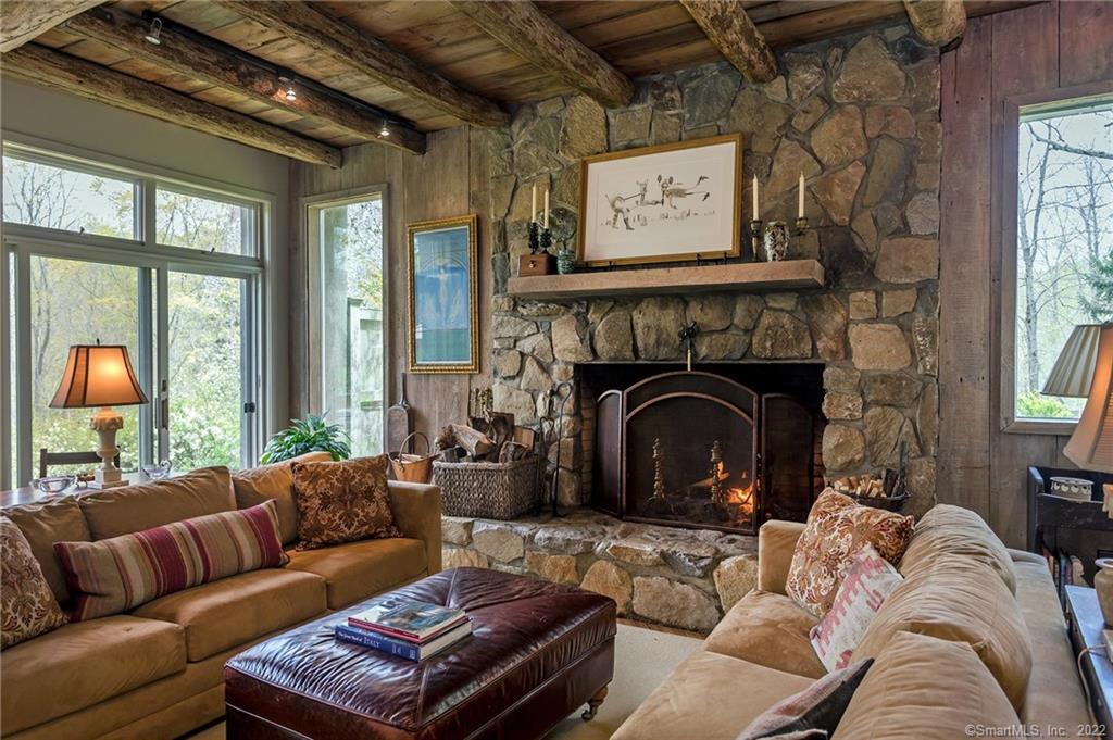119 New Milford Road West Bridgewater, CT 06752 - Photo 1 of 1 Living room with stone fireplace, beams. sliders to terrace