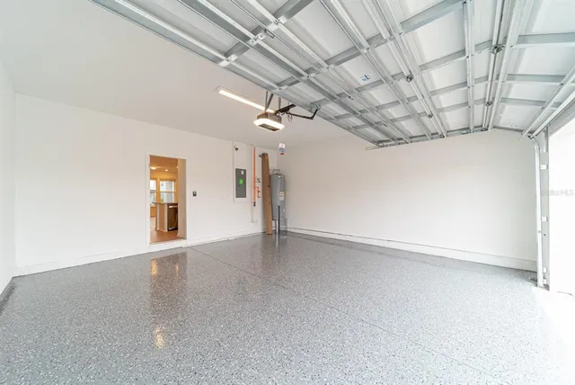 en empty room with windows and ceiling fan