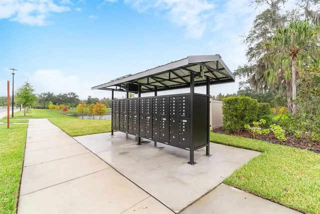 a front view of a house with a garden and trees