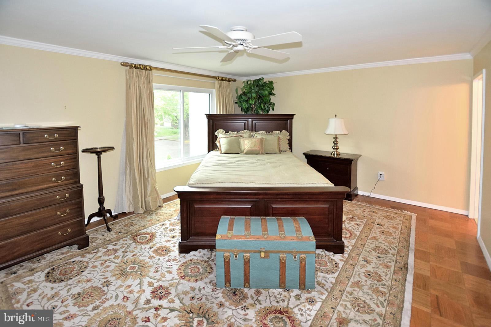 1769 Ivy Oak Square Reston, VA 20190 - Photo 14 of 24 a bed sitting in a room next to a window and a chandelier