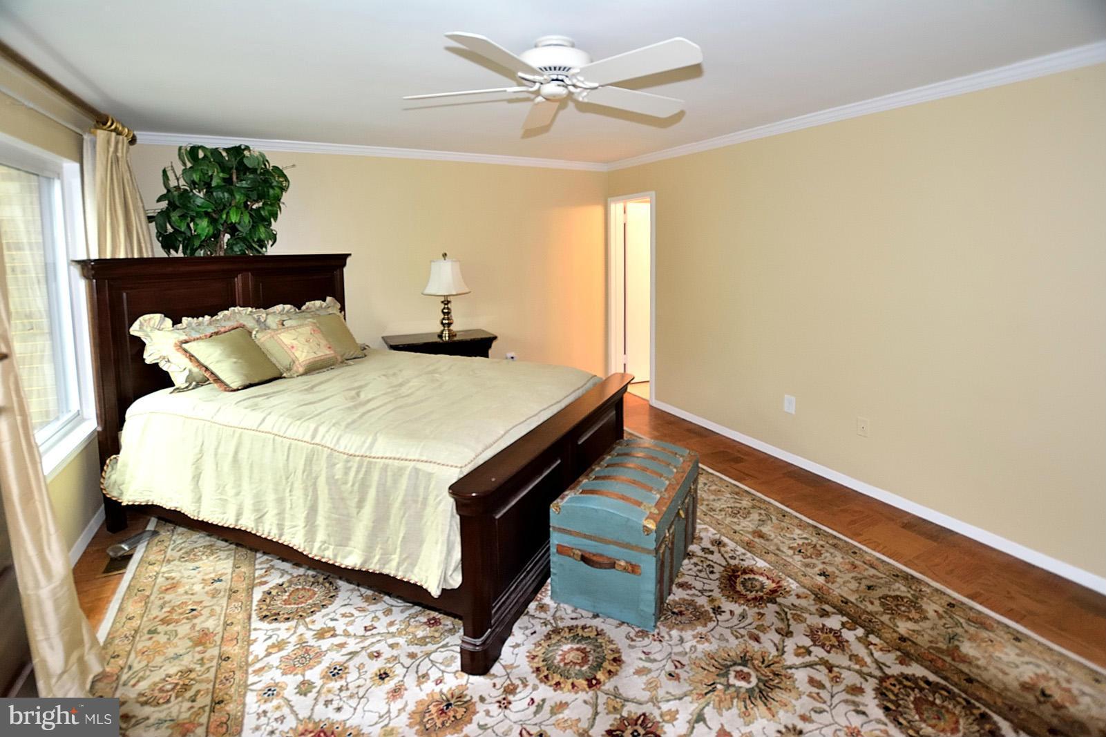 1769 Ivy Oak Square Reston, VA 20190 - Photo 15 of 24 a bed sitting in a bedroom next to a window with a chandelier
