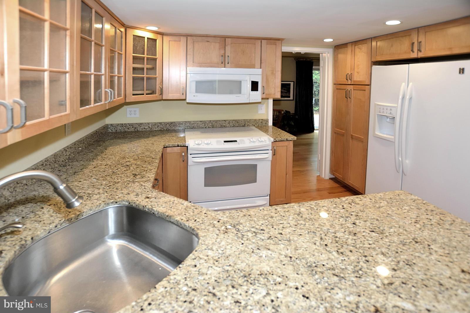 1769 Ivy Oak Square Reston, VA 20190 - Photo 3 of 24 a kitchen with stainless steel appliances granite countertop a sink stove and refrigerator