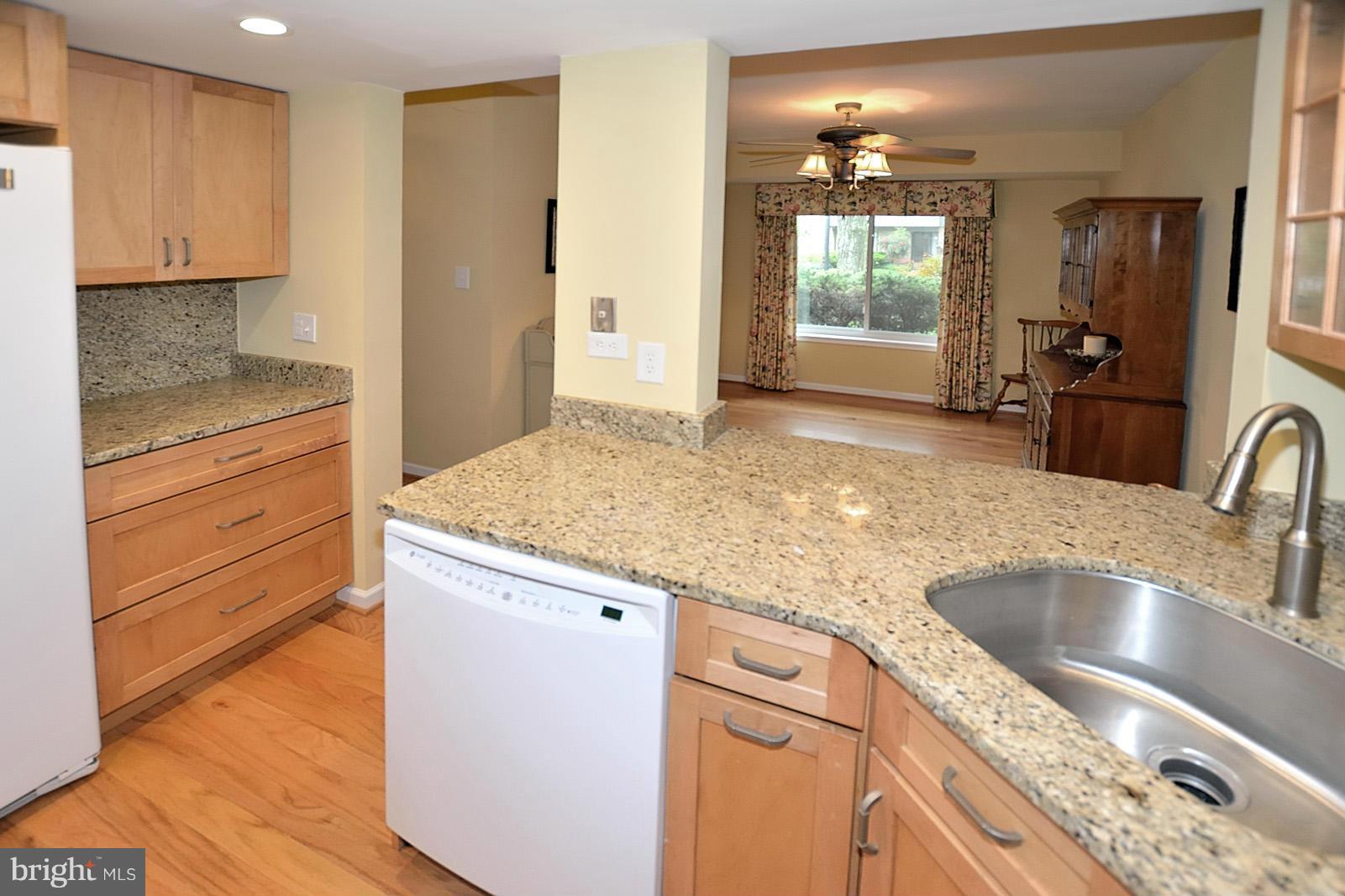 1769 Ivy Oak Square Reston, VA 20190 - Photo 4 of 24 a kitchen with granite countertop a sink cabinets and wooden floor