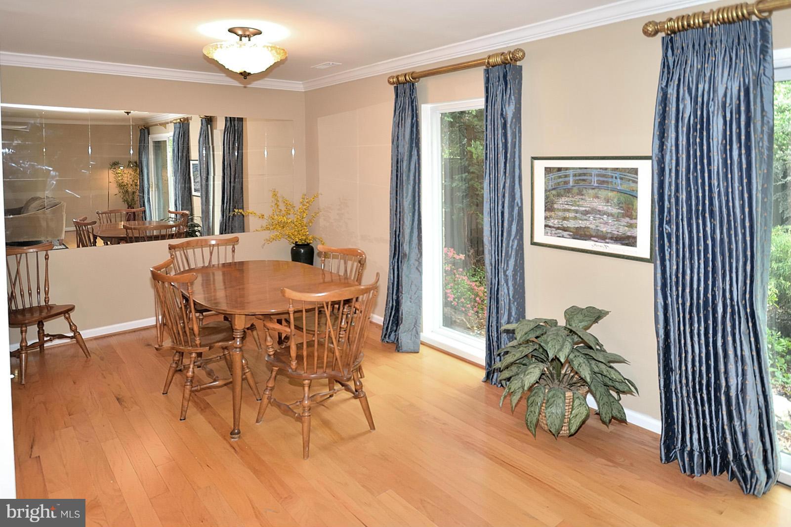 1769 Ivy Oak Square Reston, VA 20190 - Photo 9 of 24 a dining room with furniture potted plants and wooden floor