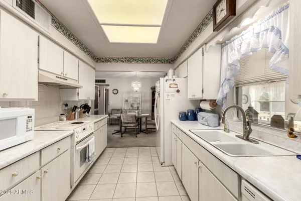 a kitchen with stainless steel appliances a refrigerator sink and cabinets