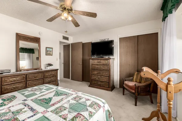 a spacious bedroom with a bed and a couch