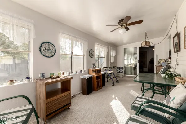 a view of a livingroom and a dining room with furniture window and outside view