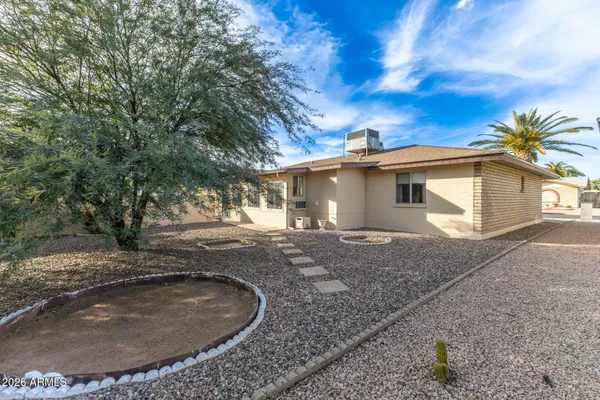a view of a backyard with a tree