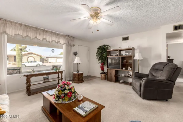 a living room with furniture and a large window